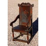 A Charles II joined oak Wainscot chair, dated 1672, carved panel back, downswept arms, plank seat,