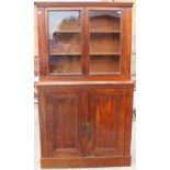 A Victorian mahogany campaign bookcase, the upper section fitted with two glazed doors,