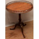 A George III mahogany tripod table, the single plank top, with a spindle gallery to edge,
