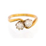 A two stone diamond cross-over yellow gold ring,