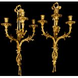 A pair of 19th Century ormolu triple light wall sconces, of Louis XVI design, ribbon finials,