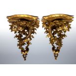 A pair of Rococo design gilt carved wood wall brackets, 18th Century or later,