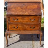 An early 20th Century Queen Anne style walnut bureau, raised on cabriole legs, 100cm high,