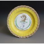 A Derby yellow ground fluted rim plate with gilt borders, painted with a horses head and monogram F,