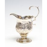 A George III silver ogee shaped cream jug,