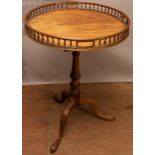 A George III mahogany tripod table, with tilt-top bird cage mechanism,