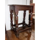 A Charles II oak joint stool, circa 1670, single plank seat, moulded edge, turned supports,