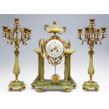 A late 19th Century French gilt metal and green onyx clock garniture, the enamel dial signed A.