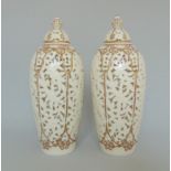 A pair of Graingers Worcester reticulated vases and covers, decorated with gilt rims and borders,