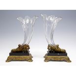 A pair of 19th Century clear cut glass cornucopia table ornaments, black slate and cast brass bases,