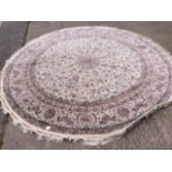 A circular Persian design cream ground rug,