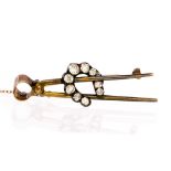 An Edwardian diamond-set horseshoe and farrier pliers yellow gold brooch,