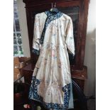 A 1920's Japanese silk embroidered cream and blue kimono, side buttoned,