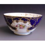 An English porcelain slop bowl, decorated in cobalt blue gilt and floral panels,