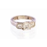 A diamond three stone platinum ring, set with three Asscher cut diamonds,