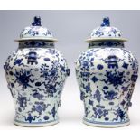 A large pair of 19th Century Chinese provincial blue and white temple vases and covers,