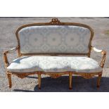 A French giltwood three seater settee, gilt gesso frame, probably late 19th or early 20th Century,
