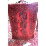 An Afghan medallion pattern rug on red ground,