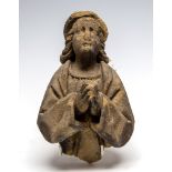 A Medieval carved sandstone figure of eclesiastical robed man at prayer,