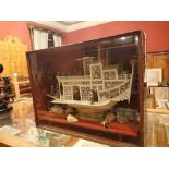 An early 20th Century Chinese ivory and bone model of a pleasure boat/junk with people having tea,