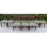 A set of ten Victorian mahogany balloon back dining chairs, with overstuffed seats,