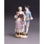 A Meissen figure of a courting couple, she holding flowers in her right hand and in her apron,