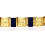 A lapis lazuli and 14ct yellow gold bracelet, four stylised floral carved lapis lazuli panels,