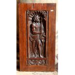 Early 17th Century carved panel of 'St John The Baptist' holding a crucifix within a knulled niche