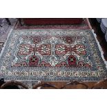 A caucasian terracotta brick red blue and cream carpet,