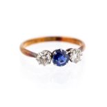 A sapphire and diamond three-stone ring, central round-cut blue sapphire approx 4.