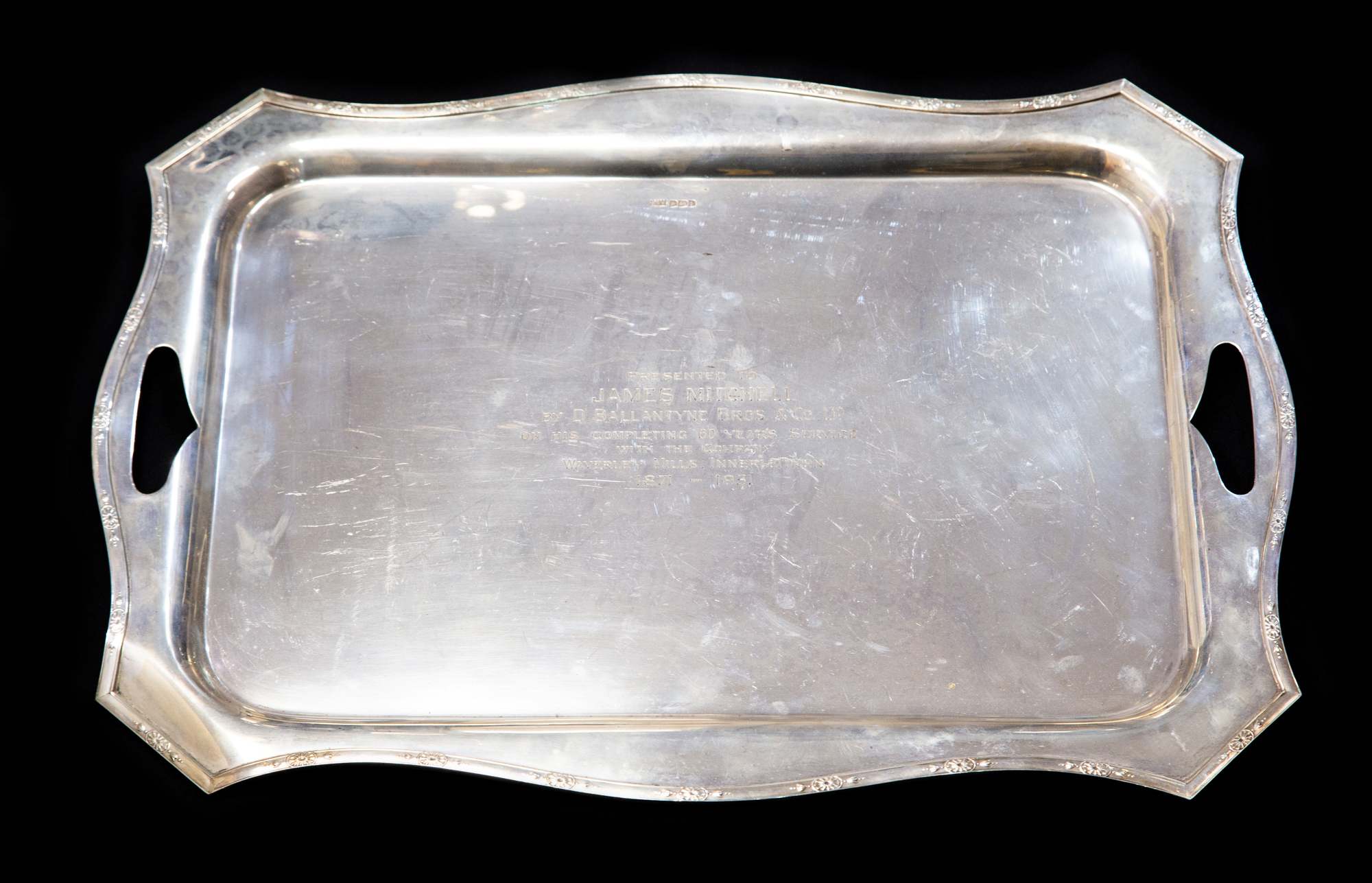 A George V large silver tray with intregal handles, engraved and chased with a border,