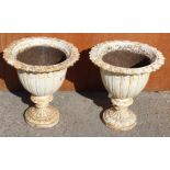 A pair of Victorian cast iron white painted pedestal urns,