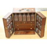 A George III mahogany medicine cabinet, circa 1810, swing handle,