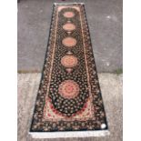 A Karaja style runner, dark blue ground with pole sunburst pattern,