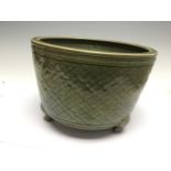 A Chinese celadon tripod censer, with incised diaper design, Ming Dynasty, 14th Century (riveted),