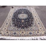 A Persian design Isfahan style blue beige and cream ground carpet,
