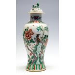 A Chinese famille verte baluster vase and cover, 19th Century, decorated with birds amongst plants,