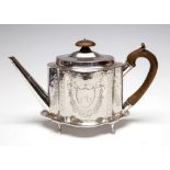 A George III silver bright-cut engraved shaped oval teapot and stand, with wavy sections,