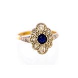 An Edwardian sapphire and diamond oval cluster ring, waved borders,