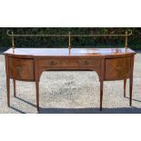 A George III mahogany bow fronted sideboard, with a brass gallery top,