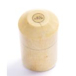 A 19th Century turned ivory vessel with screw top, inset yellow metal disc with monogram,