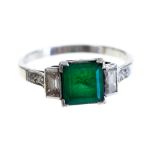 An Art Deco style emerald and diamond three stone platinum ring,