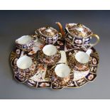 An Edwardian Royal Crown Derby 2451 imari pattern tea service, comprsing tea pot, sugar bowl,