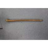A Tribal club, the plain tapered shaft with spot decoration to globular top,