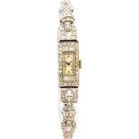 An Art Deco diamond and platinum cocktail watch, rectangular dial with diamond bezel,