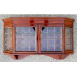 An Edwardian Liberty and Co mahogany hanging wall cabinet,