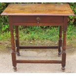 A late 17th or early 18th Century joined oak side table, plank top, fitted with a single drawer,