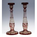 A pair of 19th Century Bohemian ruby flashed clear cut glass candlesticks, hobnail cut stems,