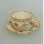 A Royal Worcester Reticulated tea cup and saucer, with honeycomb piercing picked out in turquoise,