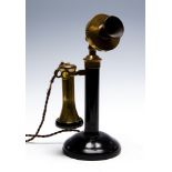 A circa 1920's candlestick telephone, black metal with brass fittings and vulcanite mouthpiece,